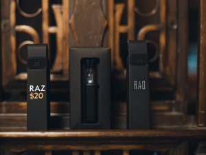 A price tag on a Raz disposable vape compared to a price tag on a boxed vape starter kit