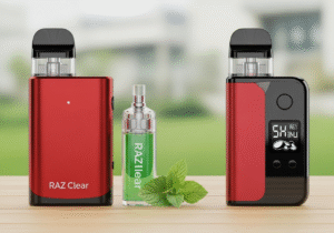 A person vaping a discreet device while working on a laptop with a cup of coffee nearby, looking focused.