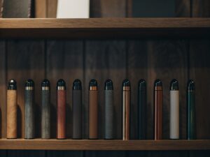 A shelf in a clean, modern UK vape shop showing only smaller, TPD/TRPR compliant 600-puff disposable vapes.