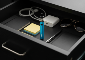 A Raz vape stored neatly in a cool, dark drawer next to other personal items